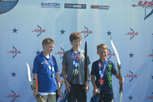 3 barebow archers on the medal stand at JOAD Outdoor Nationals in Raleigh, NC. The young gentleman in the center with the gold is a WRA archer.