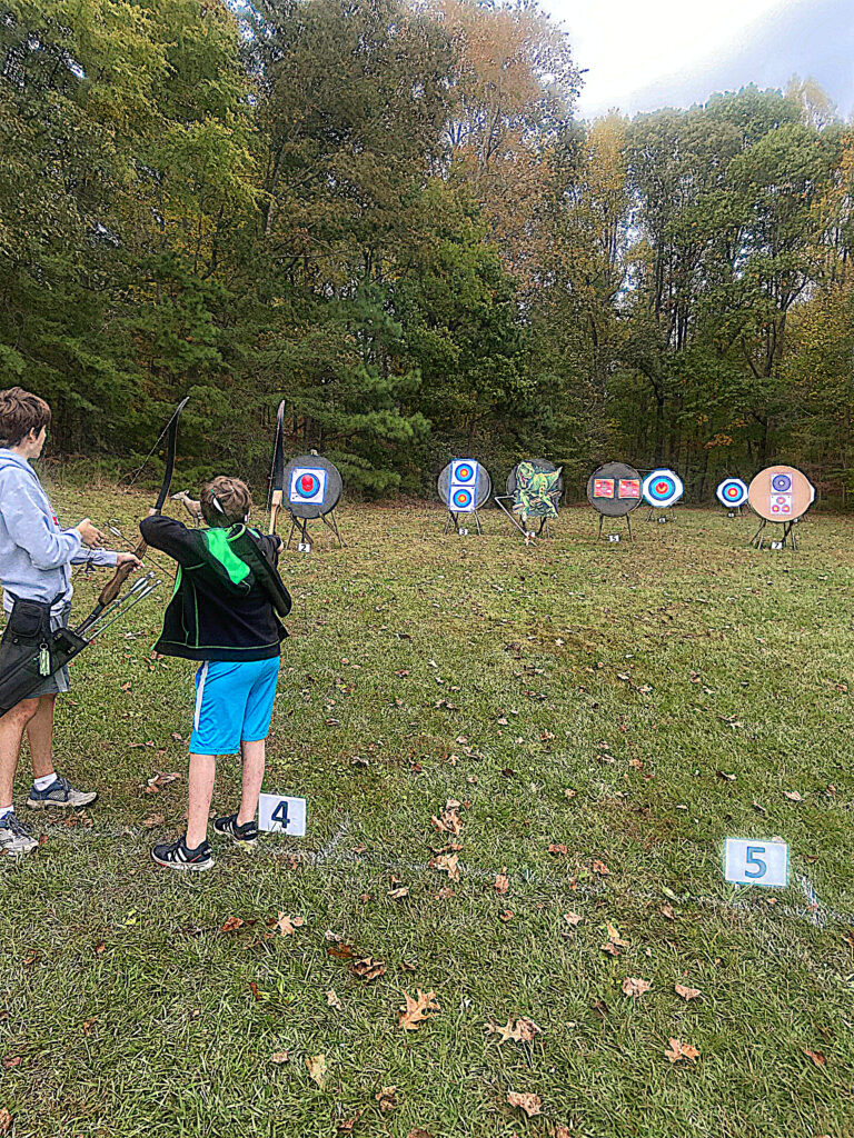 Young archers shooting at halloween themed targets