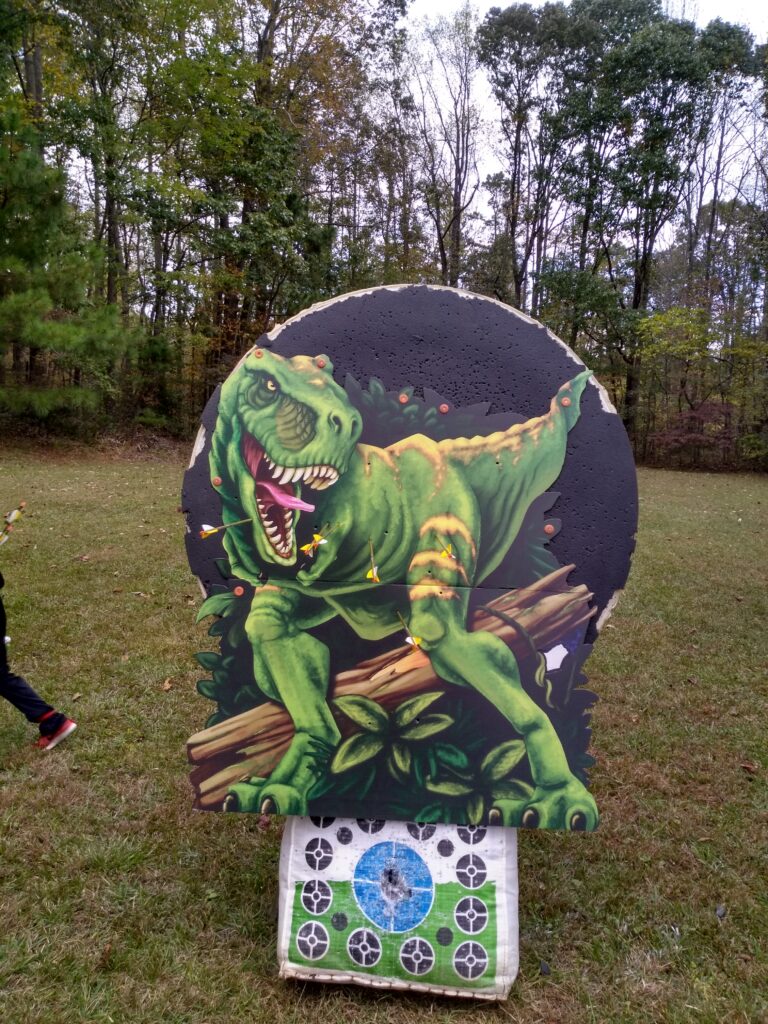 A large colorful T-Rex attache dto a target face.