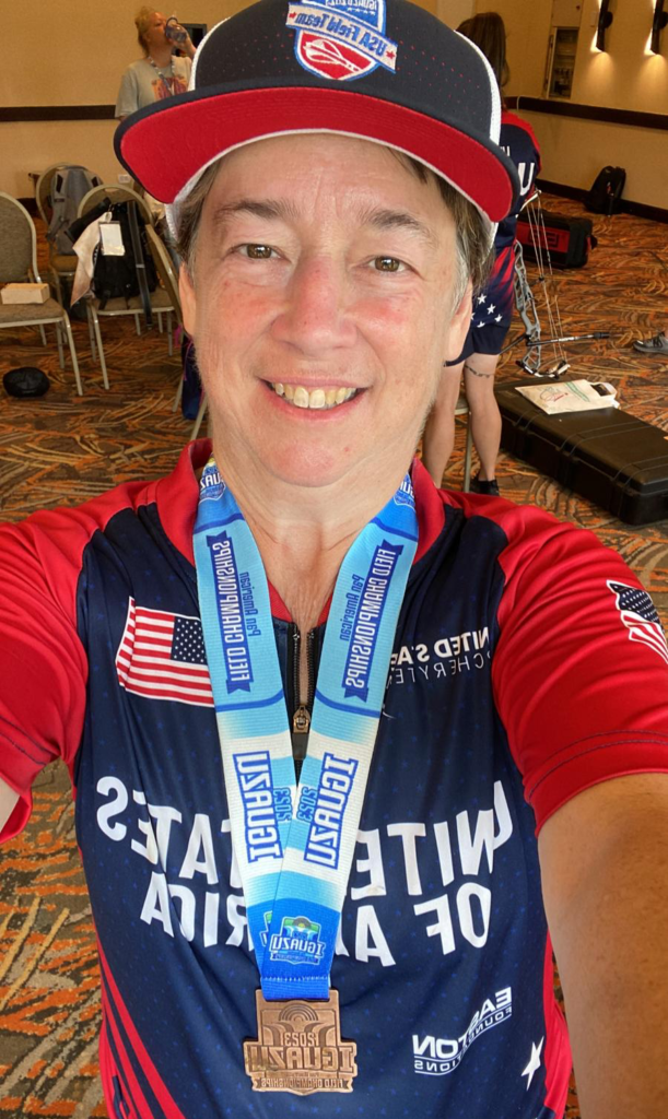 Female archer selfie displaying her 3rd place, bronze medal from the Pan Am Field Championships
