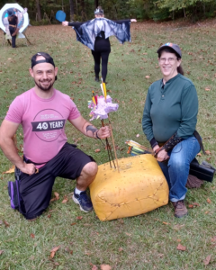 Two archers pictured with their catch - the wily pink unicorn.